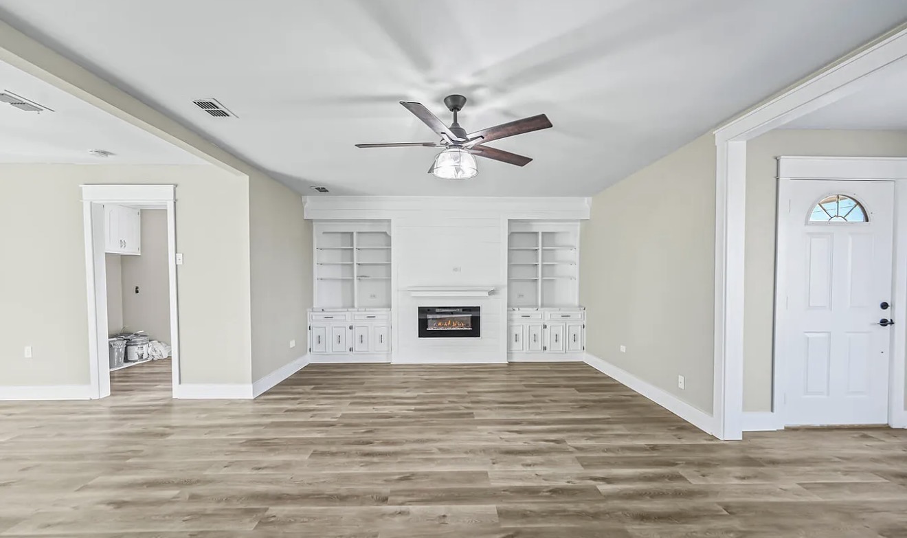 Finished custom fireplace and built-in feature wall